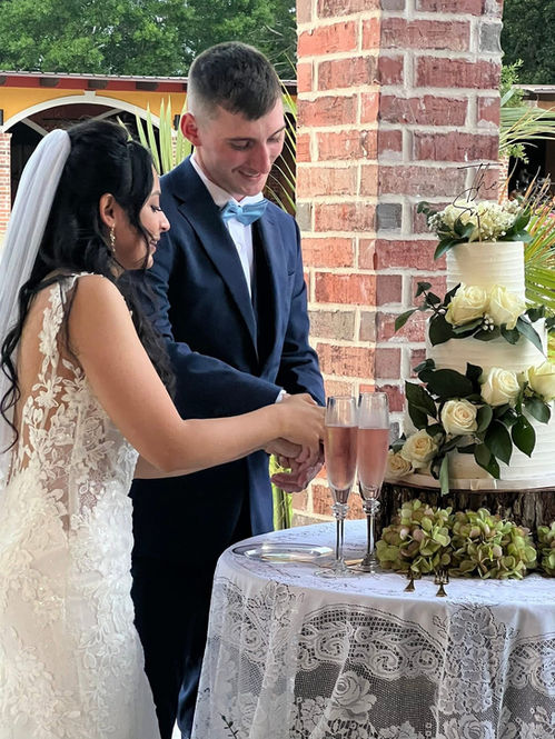 wedding couple cutting cake at La Hacienda Venue