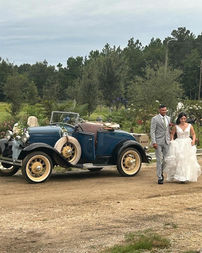 Bride and groom walking away from classic car at La Hacienda Venue