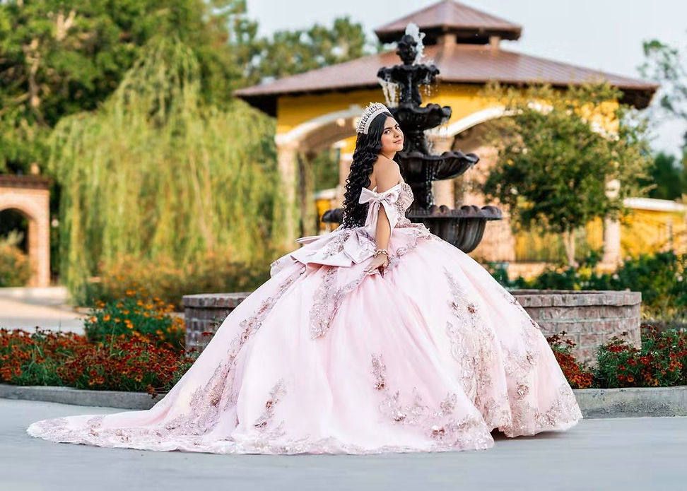 Girl celebrating her quinceañera posing in front of fountain at La Hacienda Venue in Pass Christian Mississippi