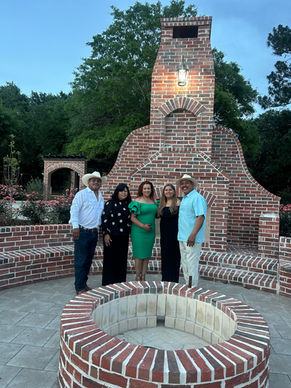family in front of fire pit at La Hacienda Venue