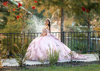 girl celebrating her Quinceañera in front of pond at La Hacienda Venue in Pass Christian MS