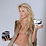 Young girl waering a fur vest while posing with guitar pedals.