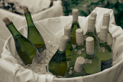 Bottles of wine chilled in ice bucket.