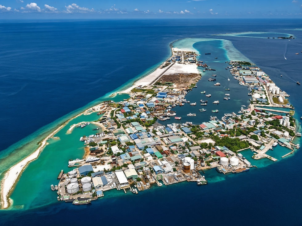Aerial view of Thilafushi, the artificial island in the Maldives known as "Trash Island," serving as a key waste management and industrial hub, showcasing a mix of industrial facilities and vibrant marine surroundings.