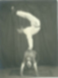 You can see Robert’s hands gripping a small block. This block was attached to a "board" strapped around Amanda’s waist. This small block was on a revolve-ratchet, and Robert "revolved" in a complete circle while holding this handstand position. Note, also, that this handstand position was not "pressed" into, Robert "kicked up" from the floor. This required endless practice, because the kick or "strike" had to be perfect. With the hands in this close, wrist-to-wrist position, Amanda as a "living table" with the natural movement of "life", there was little leeway for error.