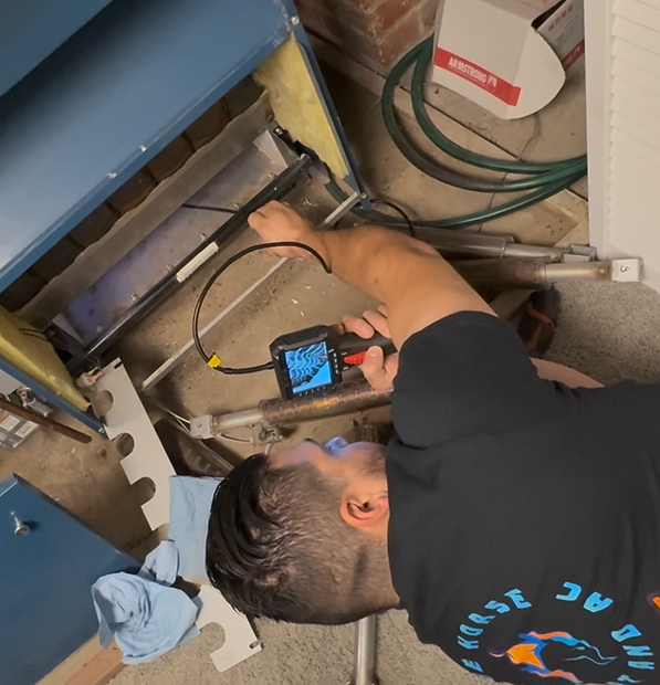 Technician inspecting HVAC unit for central air conditioning repair