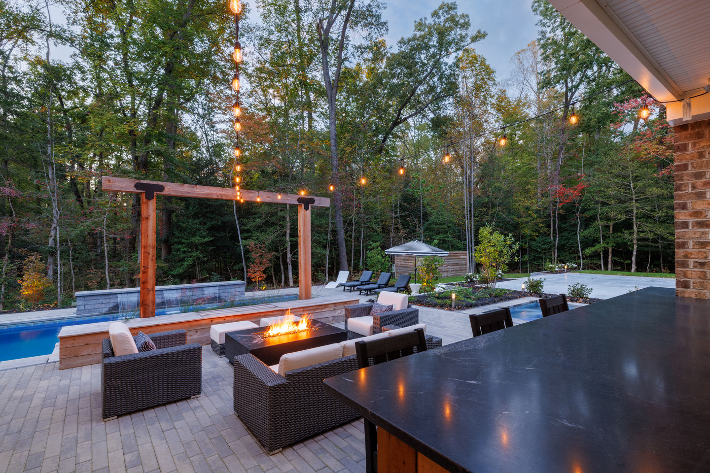 a patio area with a fire pit and a pool