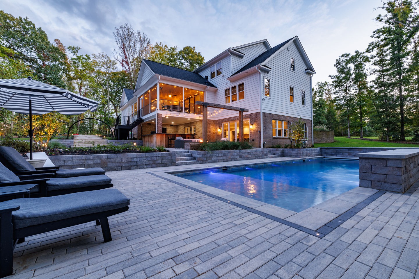 a large house with a large swimming pool in front of it