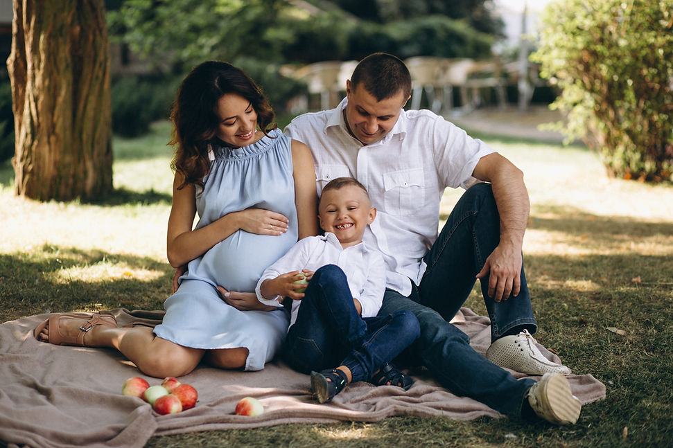 husband-with-pregnant-wife-their-son-having-picnic-park.jpg