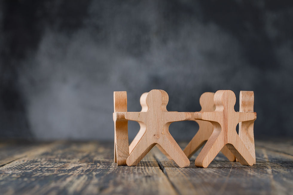 Wooden people holding hands in a circle