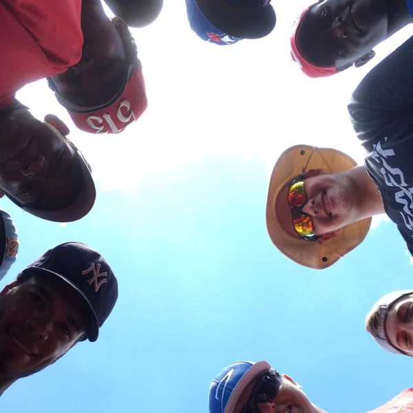A coach and players look down into the camera.