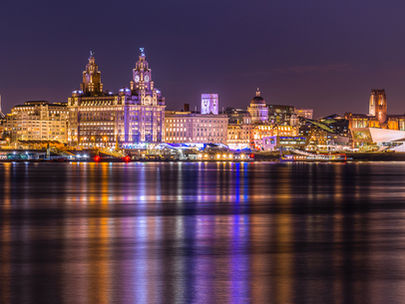 Liverpool waterfront at night time, many bright lights of the city can be seen