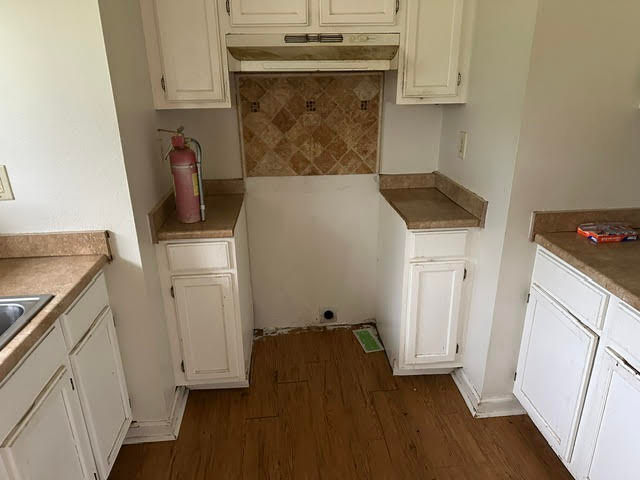Interior painting service for white kitchen cabinets.