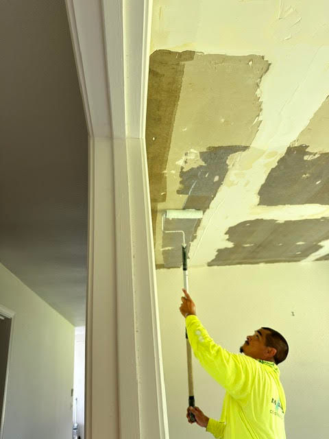 Professional interior painting service on a ceiling.