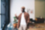 happy-black-man-standing-with-smartphone-at-home-2024-01-31-15-19-15-utc.jpg
