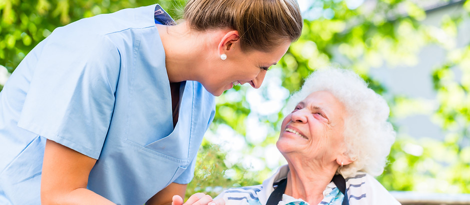 Nurse holding hand of senior woman in pe