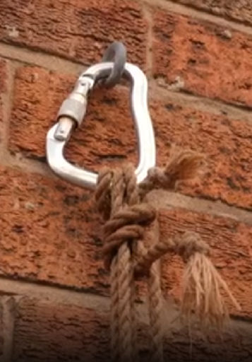 Wet jute rope is tied off with tension.
