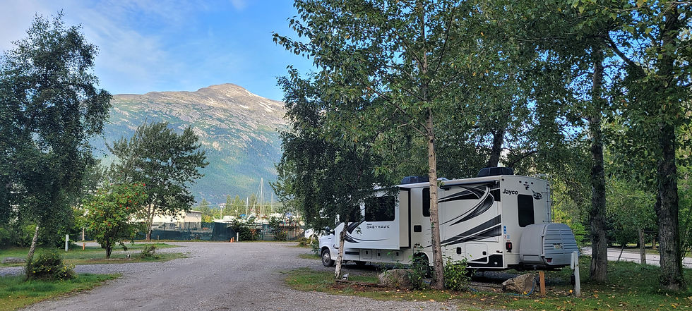 Our very pleasant campsite in Skagway, Alaska, across the street from the Pullen Creek Shoreline Park and StreamWalk. During the week that Alison's college friend, Sarah, was visiting us, we discovered that the back slide wouldn't retract (when we tried to close up to visit the dump station). Alison researched (thank goodness for YouTube!) and the three of us implemented a manual retraction (electrical button codes to unlock the slide, then pushing in the slide from the outside, then re-coding the slide to lock into place). Doug and Alison survived the minimized space for the next few weeks!