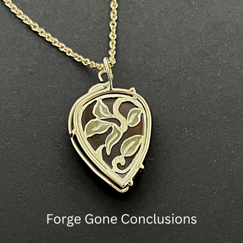 Opal Guitar Pick Necklace Back of Piece on Black Background