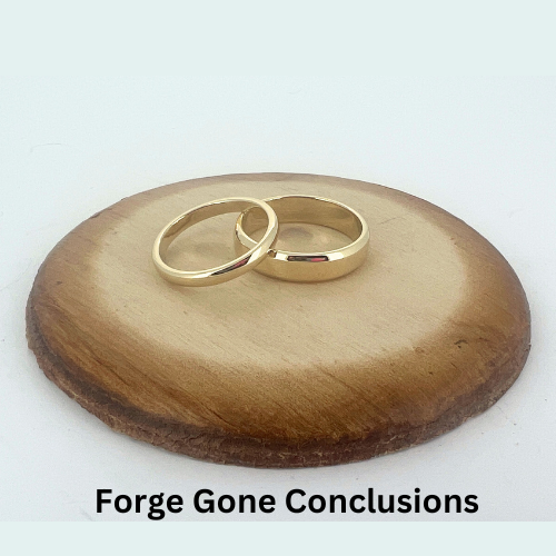 Simple Gold Wedding Bands on wood backing