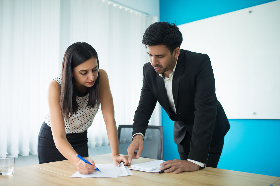 serious-businessman-businesswoman-signing-contract.jpg