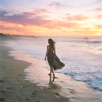 female walking towards the misty water o