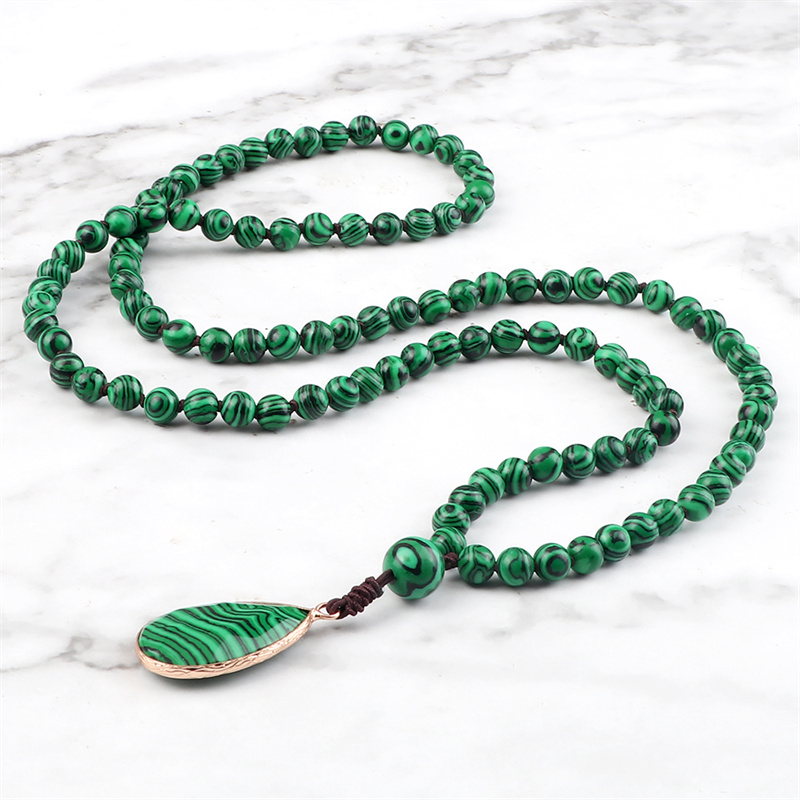 Malachite necklace styled on a neutral background