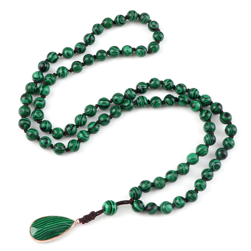 Close-up of natural malachite beads showing unique green banding