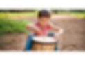 childrens natural outdoor drum being played by a kid_edited_edited.png