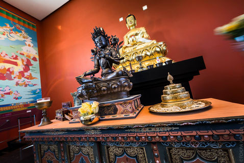 Dark central statue arranged on an altar with gold figures and offerings — Benalmadena, Malaga, Spain — February 2015 — The Statues of Benalmadena Enlightenment Stupa — photograph by Tokpa Korlo