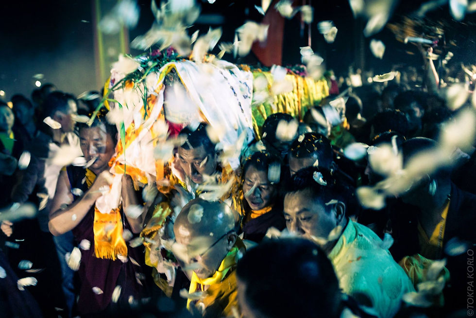 Night procession carrying a flower-covered ceremonial bier beneath a shower of white petals — Kudung — March 2015 — Kudung: A Journey Of Color and Light — photograph by Tokpa Korlo