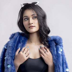 A playful fashion editorial by Kumar Piyush featuring bold  color blocking with a striking cobalt blue fur jacket. Shot  agai