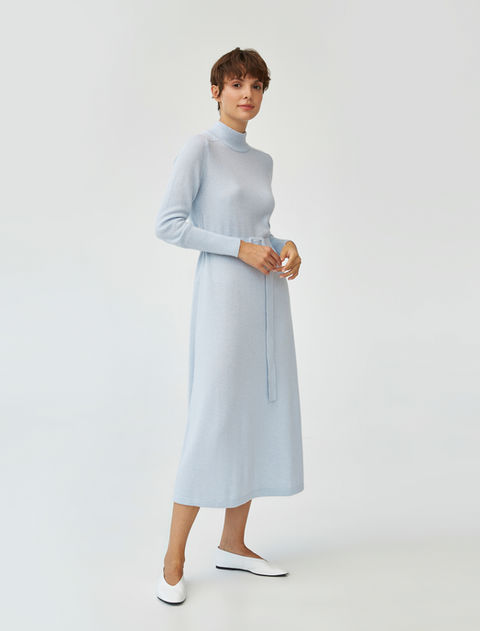 Woman in light blue dress and white flats
