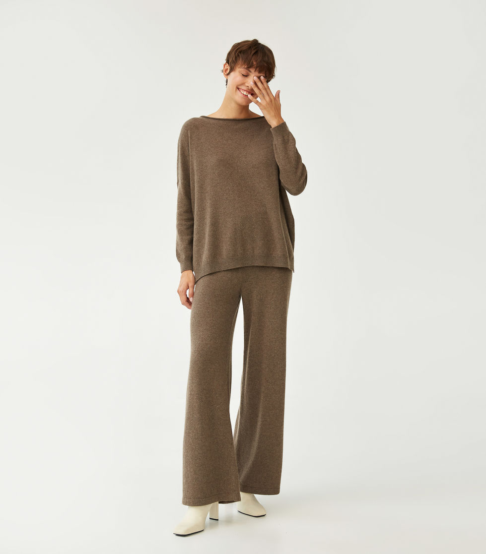 Person wearing a brown sweater and pants set.