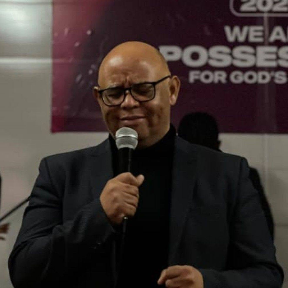 Man speaking at a Who We Are church event with microphone.
