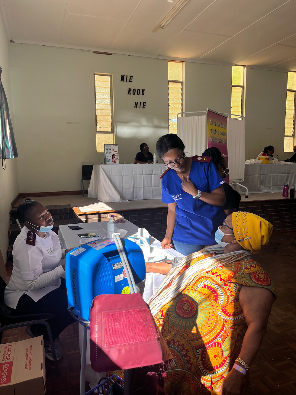 Healthcare workers assisting a woman during community missions.