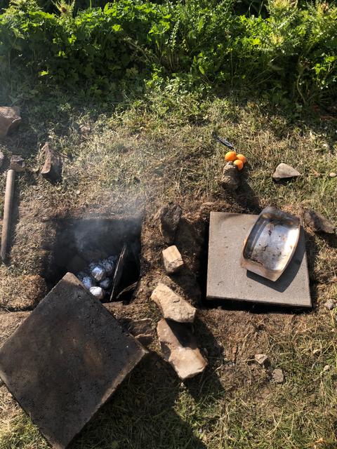 potatoes baking in handmade ground oven 