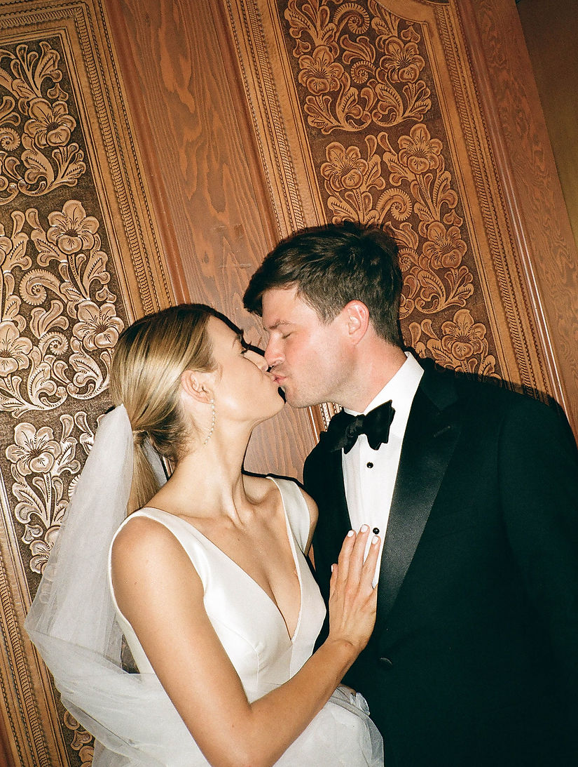 bride and groom in elevator kissing