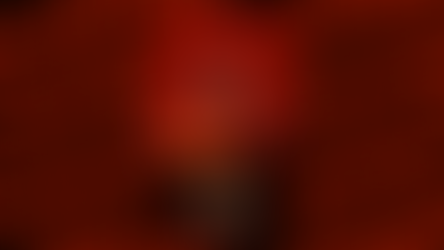 Silhouette of a wolf in a suit with red eyes in front of a red sunset. Text: The Bad Guys 2, In Theaters This Summer. Mood: mysterious.