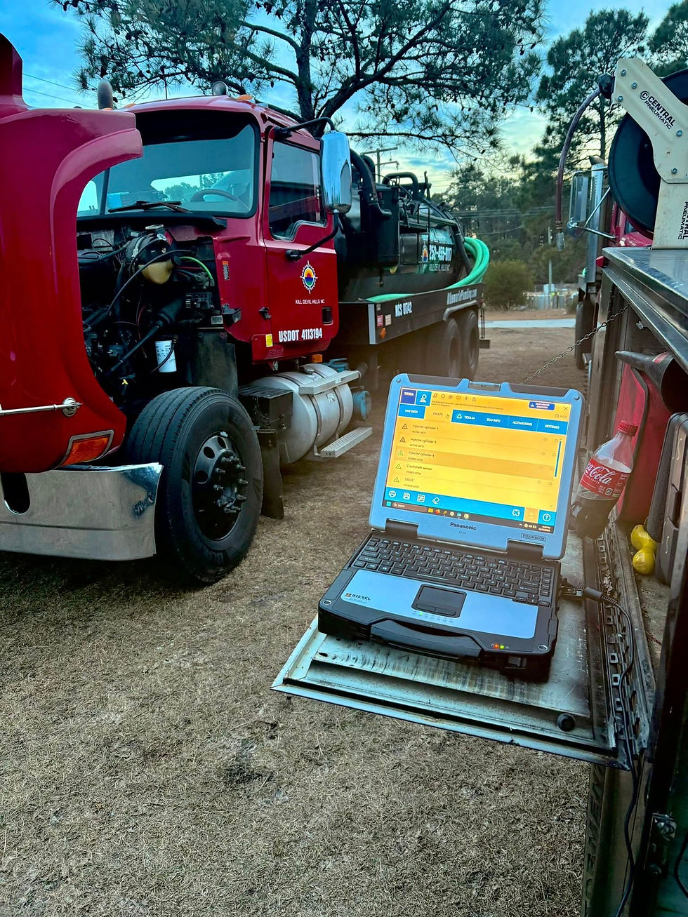 Laptop diagnosing red semi-truck for grandy fleet maintenance