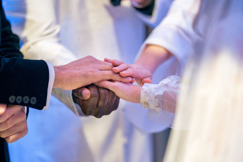 a couple holding hands with their officiants at their co-officiated interfaith wedding at The Connecticut Shoreline