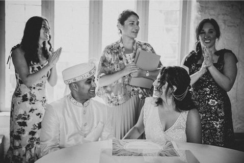 a bride and groom signing the ketubah at their co-officiated wedding in Westchester, New York