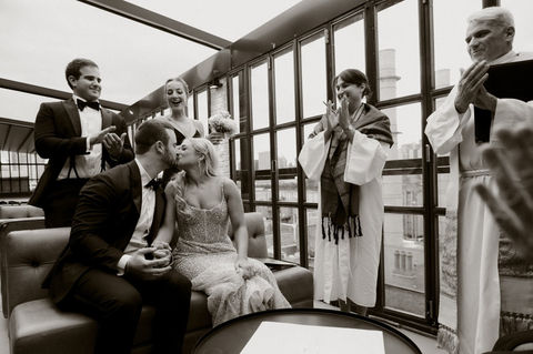 a bride and groom kissing at their co-officiated wedding in New York City, New York