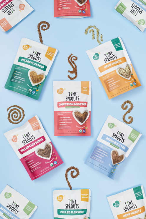 Flat lay pattern of Tiny Sprouts nutrition packages with each product forming elegant swirls, showcasing the wholesome ingredients in a creative way.