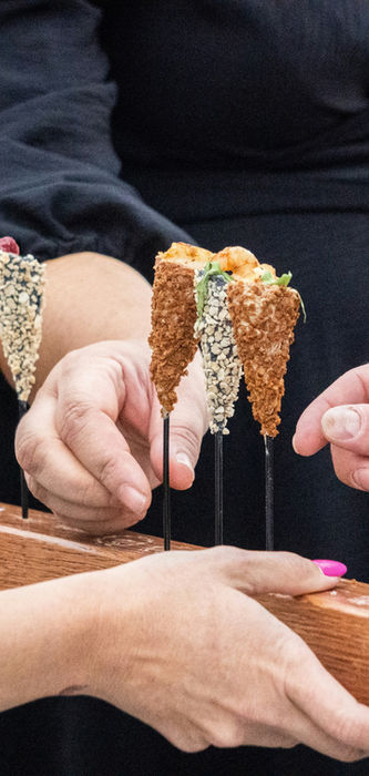 Guests enjoying mini kosher appetizers served by Elegant Kosher Catering at a private event in Miami-Dade