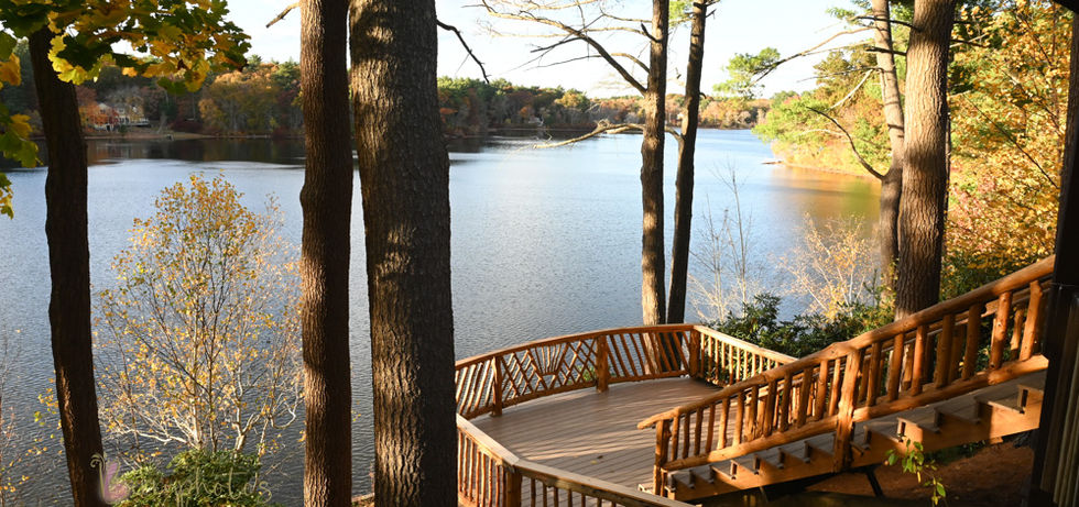 From the back left side of the building looking down towards the rear deck and stairs that lead to the lake at Camp Kiwanee in Hanson MA