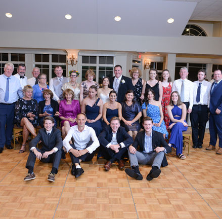 34 person group shot on the dance floor of Granite Links in Quincy MA. Lit perfectly with two off-camera flashes on poles coming from both sides to evenly light the large group.