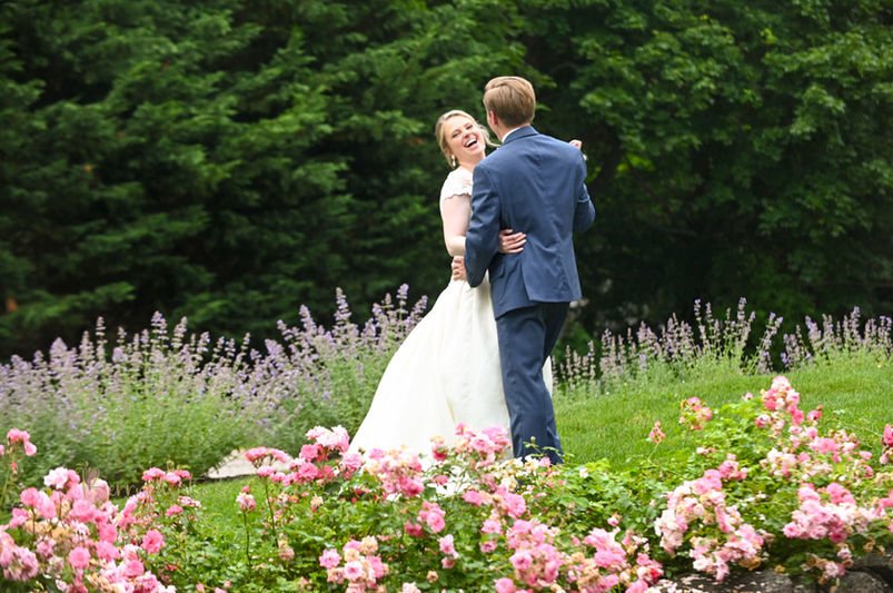 This cape cod wedding shows the couple dancing in the gardens of this art gallery with the bride beaming with excitement.
