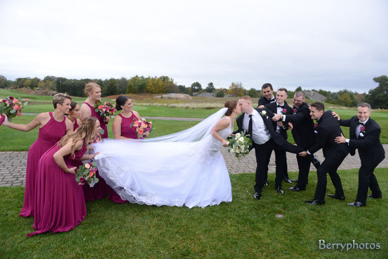 Bride and groom are being pulled apart by their wedding party as they try to kiss. Fun Cape Cod wedding with all those Cape vibes.