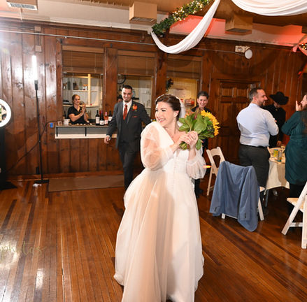 Bride standing in front of the bar on the dance floor at Camp Kiwanee in Hanson MA